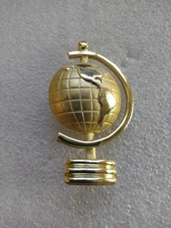 AJC gold tone globe brooch