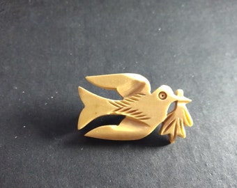 Hand-carved wooden dove with an olive branch bird brooch