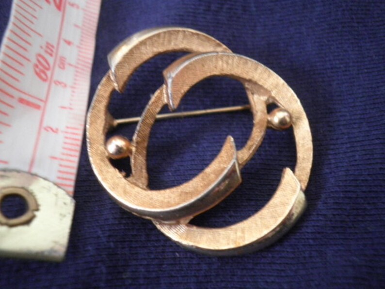 Hedy gold tone brooch