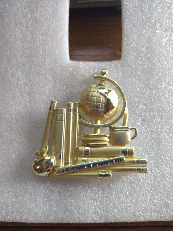 AJC 1980s gold tone teacher brooch with books and 