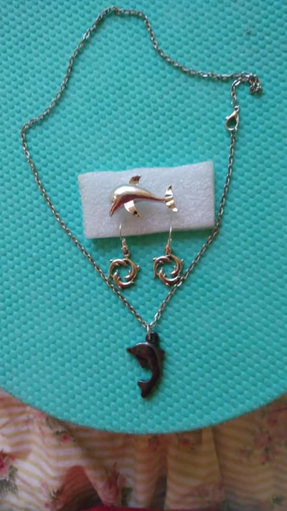 Gerry's dolphin pin, dolphin hematite pendant, and