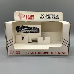 May include: A white cardboard box with red and black text and graphics. The box is labeled "Lawn Chief" and "Collectible Mower Bank." The box also features the text "A Cut Above The Rest" and a black and white image of a building.