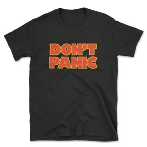 May include: Black t-shirt with the text "DON'T PANIC" in red and yellow letters.