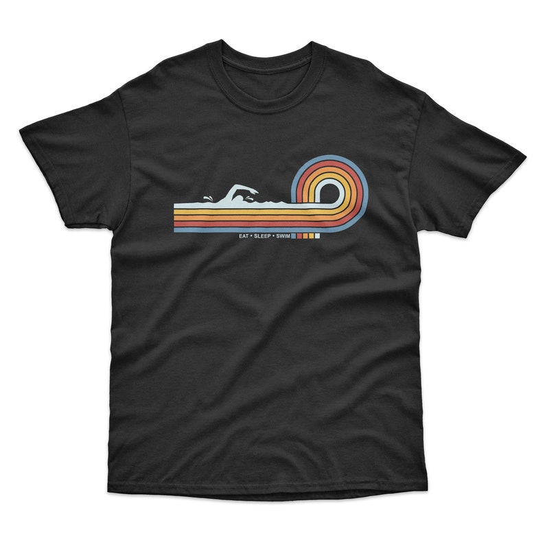 May include: Black t-shirt with a retro-style graphic of a swimmer in a wave with colorful stripes and the text "Eat Sleep Swim".
