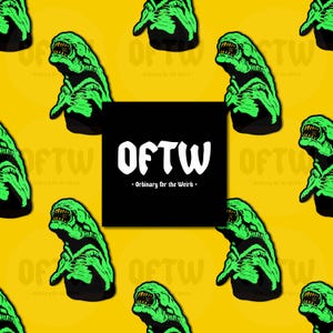 May include: A repeating pattern of green monster illustrations on a yellow background. The monsters have sharp teeth and are outlined in black. A black square with the text "OFTW - Ordinary for the Weird" is in the center.