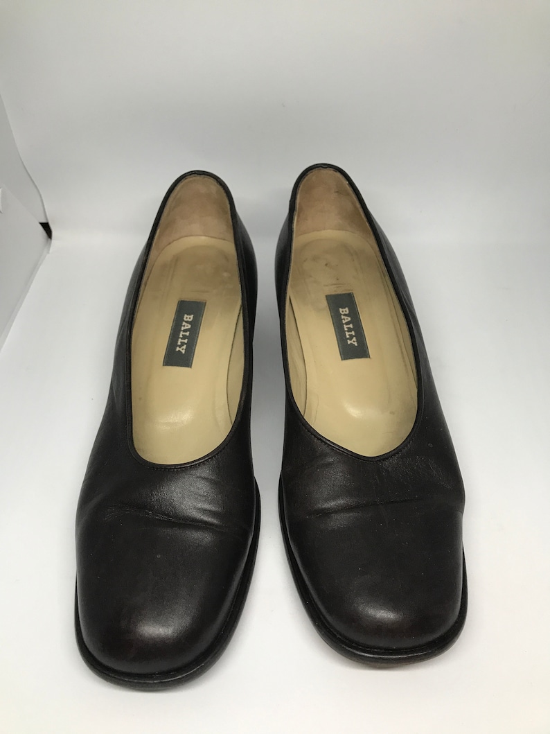 May include: A pair of black leather Bally pumps with a square toe.
