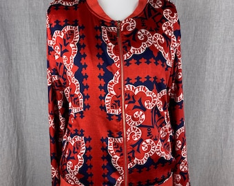 May include: A red satin bomber jacket with a blue and white print featuring the word "Valentino" repeated throughout. The jacket has a gold zipper and a ribbed collar, cuffs, and hem.