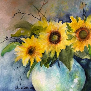 May include: Watercolour painting of sunflowers in a pale blue vase. The sunflowers have bright yellow petals and dark brown centres. Green leaves and thin branches are also visible. The artist's signature is in the bottom left corner.