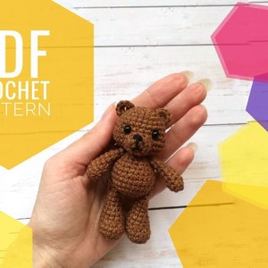 May include: A brown crocheted teddy bear with black eyes and a nose. The bear is being held in a hand. The image includes the text "PDF CROCHET PATTERN".