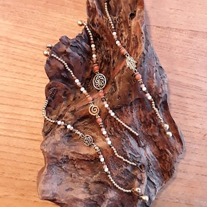 Bracelets, arm chains made of brass and stones