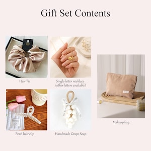 May include: A gift set with various items, including a satin hair tie, a single-letter necklace, a pearl hair clip, a handmade grape soap, and a corduroy makeup bag. The items are arranged on a light pink background.