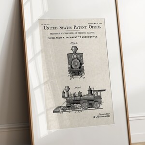 May include: Black and white illustration of a vintage steam locomotive with a snow plough attachment. The image is a patent drawing with the text "United States Patent Office" and "Snow-Plough Attachment to Locomotives".