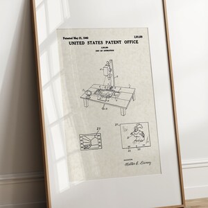 May include: A black and white line drawing of a patent for a device for making motion pictures. The patent is titled "United States Patent Office" and the patent number is 2,391,680. The patent was filed on May 21, 1940. The drawing shows a camera mounted on a stand, with a film strip and a light source. The inventor is listed as "Matthews & L'Ecuyer".