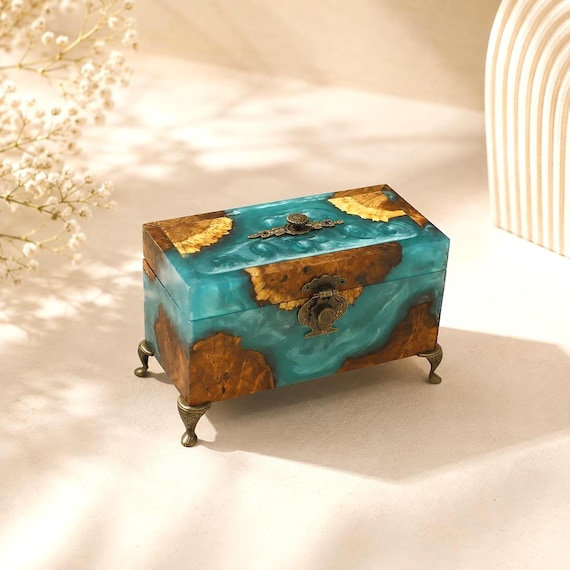 A hand-poured turquoise resin and wood jewelry box with antique-style hardware — the kind of heirloom-looking piece that looks like it took weeks to make.