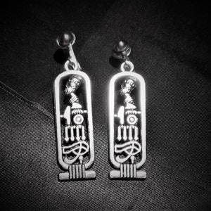 Egyptian Cartouche, Nefertiti, Eye of Ra, Ma&#39;at, Goddess Ma&#39;at Clip On Drop Dangle Silver Tone Earrings Mystical, Statement, Spiritual Magic