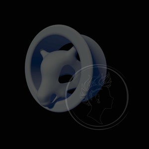May include: A gray and blue circular ear gauge with a 3D sculpted animal head design. The animal head is facing forward with its mouth closed. The ear gauge is made of a smooth, matte material.