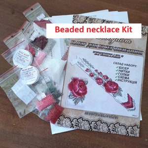 May include: A beaded necklace kit with instructions, beads, thread, and needles. The kit includes a pattern with a design of two red roses.