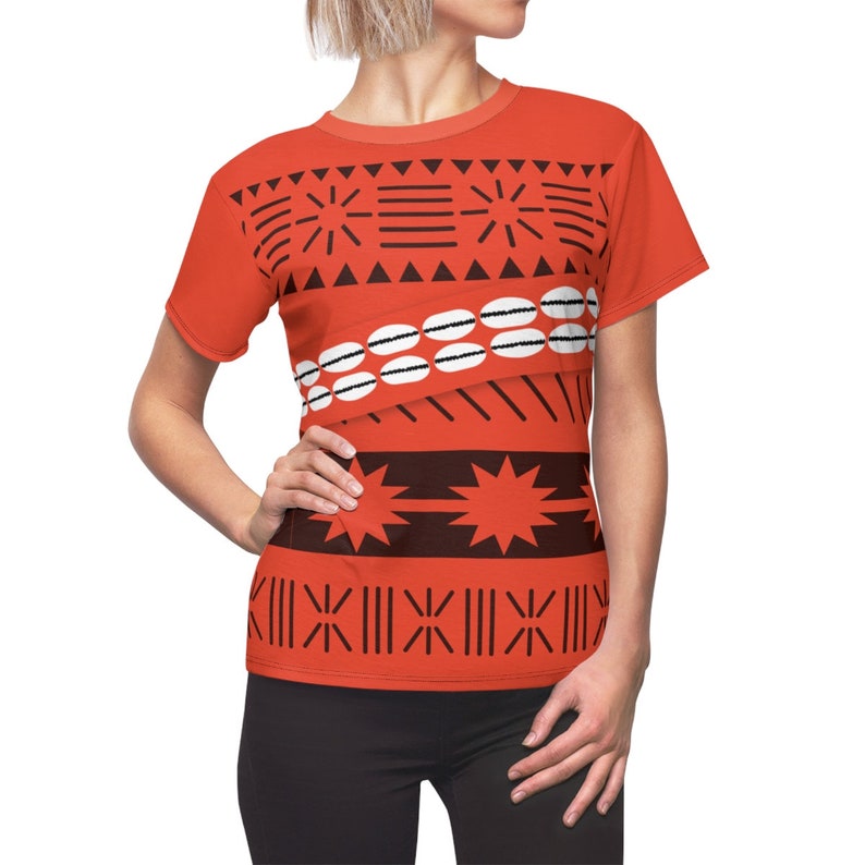 May include: Red t-shirt with a black and white geometric pattern. The pattern includes stars, lines, and circles.