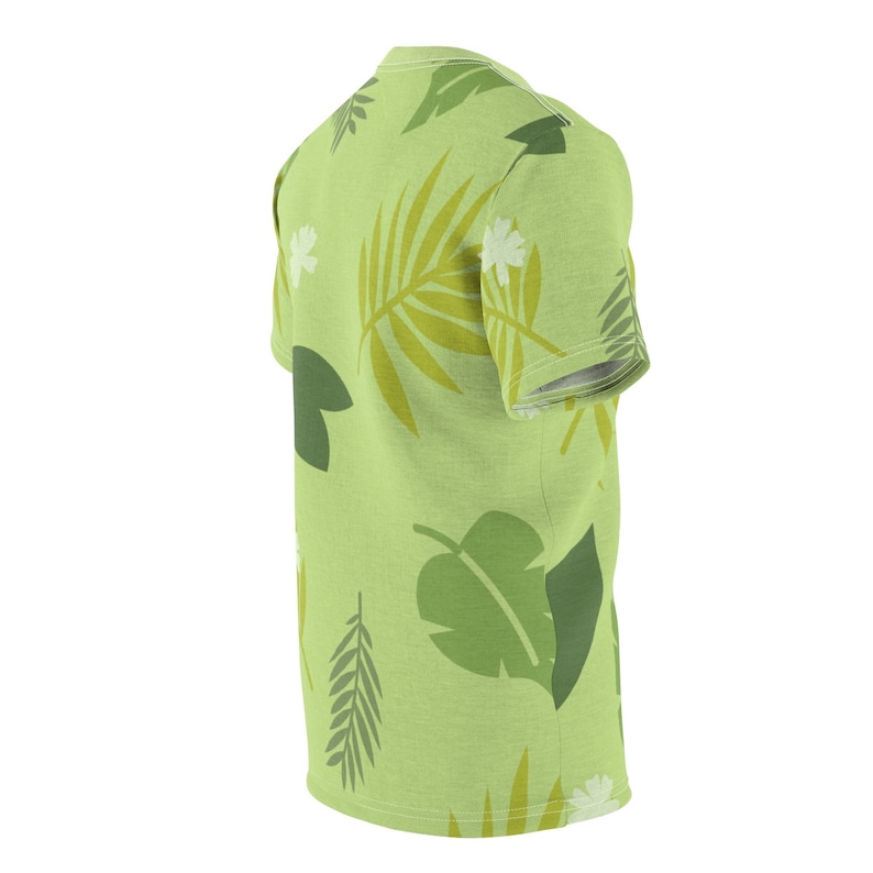 May include: A green t-shirt with a tropical leaf pattern. The shirt has short sleeves and a crew neck.