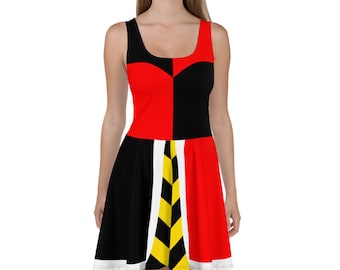 May include: A red and black skater dress with a white and yellow chevron pattern. The dress has a scoop neck and sleeveless design.