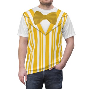 May include: A white t-shirt with a yellow and white striped pattern that resembles a tuxedo vest. The shirt has a yellow bow tie.