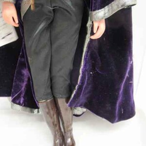 May include: A purple velvet robe with a silver trim and black pants with brown boots.