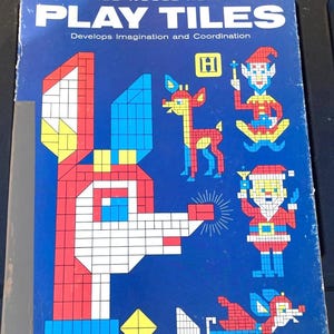 May include: A vintage "Rudolph the Red-Nosed Reindeer Play Tiles" game box. The blue box features a mosaic-style Rudolph, Santa, and other Christmas characters. The text reads "Develops Imagination and Coordination."