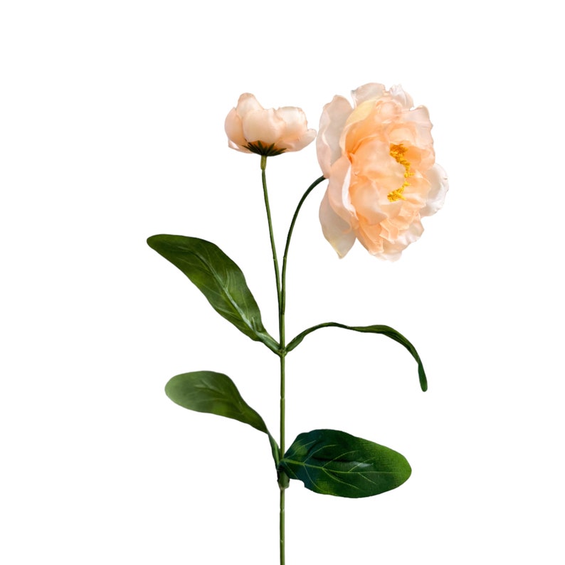 May include: A single peach-colored artificial flower with green leaves and stems.