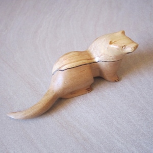 carved wooden otter in walnut. yew or spalted beech spalted beech