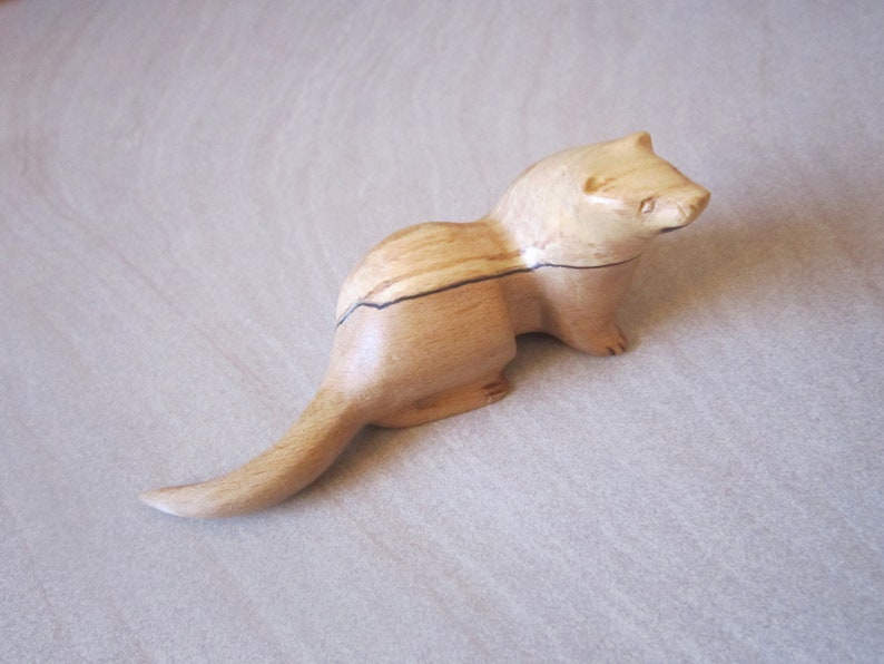 carved wooden otter in walnut. yew or spalted beech spalted beech