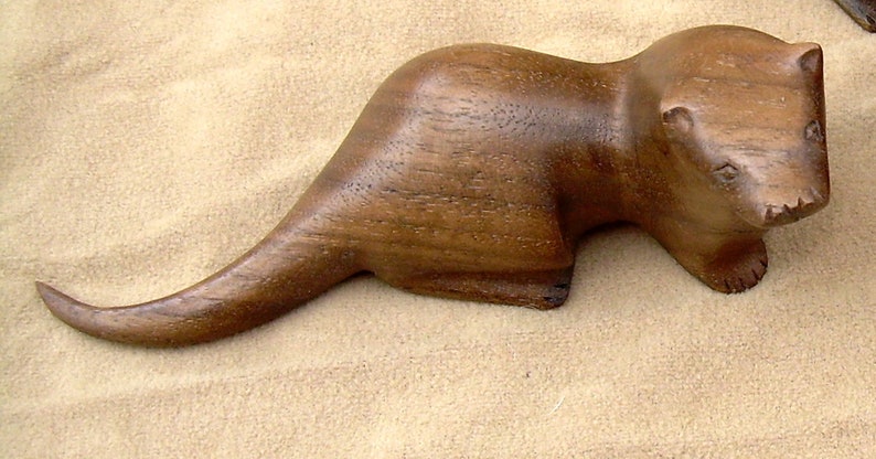 carved wooden otter in walnut. yew or spalted beech grey walnut