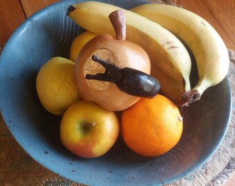 carved wooden apple with slug