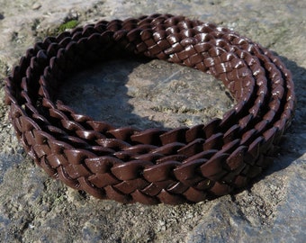 May include: A close-up of a brown leather braided strap. The strap is woven in a tight, intricate pattern and has a glossy finish.