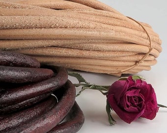 May include: Two spools of leather cord. One spool is natural brown leather cord and the other spool is dark burgundy leather cord.