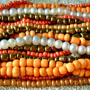 8 strands of glass beads (about 1040 beads), orange-brown tones, about 3-4.5 mm (Nr57)