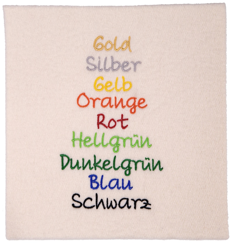 May include: A white fabric swatch with the words "Gold", "Silber", "Gelb", "Orange", "Rot", "Hellgr&uuml;n", "Dunkelgr&uuml;n", "Blau", and "Schwarz" embroidered in different colors.
