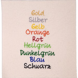 May include: A white fabric swatch with the words "Gold", "Silber", "Gelb", "Orange", "Rot", "Hellgr&uuml;n", "Dunkelgr&uuml;n", "Blau", and "Schwarz" embroidered in different colors.