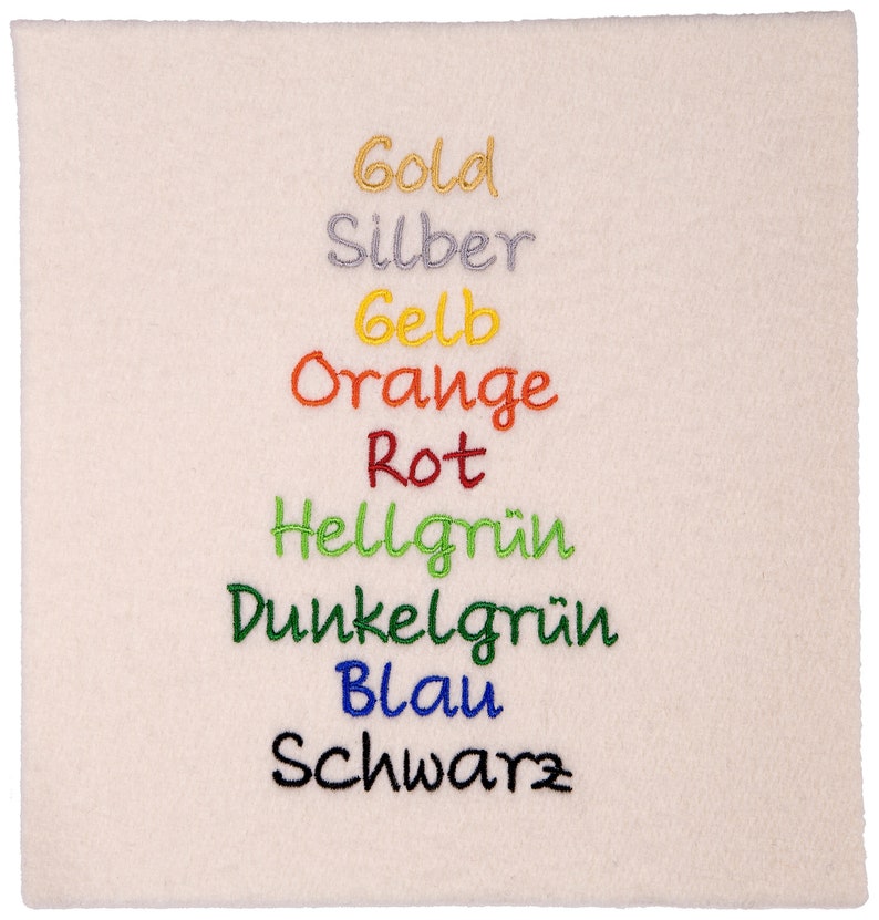 May include: A white fabric swatch with the words "Gold", "Silber", "Gelb", "Orange", "Rot", "Hellgr&uuml;n", "Dunkelgr&uuml;n", "Blau", and "Schwarz" embroidered in different colors.