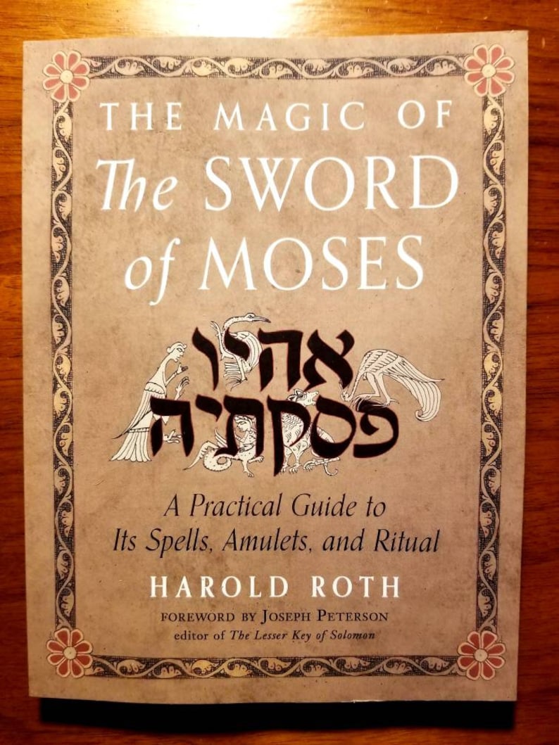 May include: A book titled "The Magic of The Sword of Moses" by Harold Roth. The cover features a decorative border with a Hebrew inscription and a foreword by Joseph Peterson, editor of The Lesser Key of Solomon.