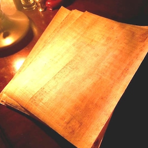 May include: A stack of light brown parchment paper with a slightly textured surface.