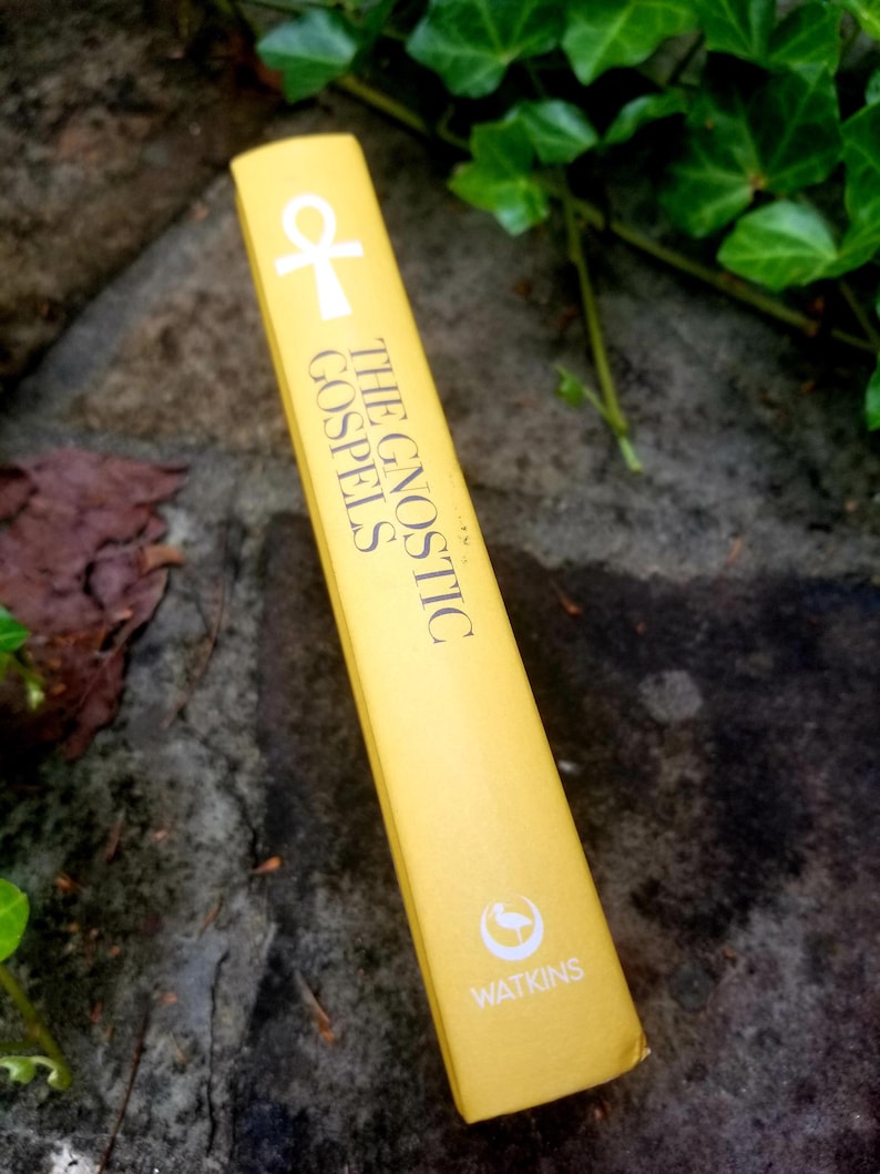 May include: A yellow book titled "The Gnostic Gospels" with a white ankh symbol and a white bird logo for Watkins.