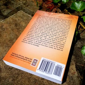 May include: The back cover of a book titled "The Lost Book of Enoch - A Comprehensive Transliteration" by Joseph Lumpkin. The book is orange and features a barcode and ISBN number. The text on the back cover describes the book as a reference guide for those interested in the Books of Enoch, Angels, Watchers, and the Nephilim.
