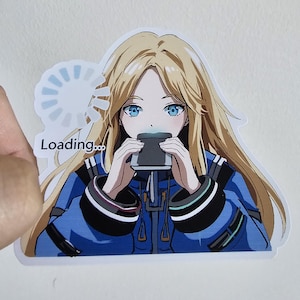 May include: A sticker featuring an anime-style illustration of a person with long blonde hair and blue eyes, wearing a blue jacket. The person is holding a black object, with the word "Loading..." above them.