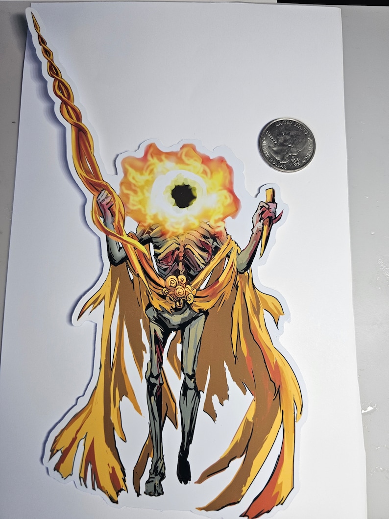 May include: A sticker featuring a skeletal figure with a flaming head and a long, twisted staff. The figure is draped in a golden cape and holds a knife. The sticker is on a white background.