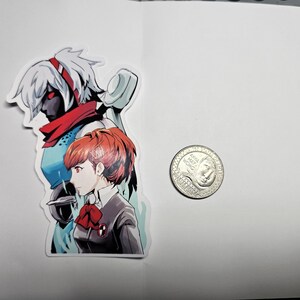 May include: A sticker featuring two anime characters. The character on the left is a woman with white hair, red eyes, and a red scarf. The character on the right is a woman with red hair, brown eyes, and a red bow. The sticker is on a white background.
