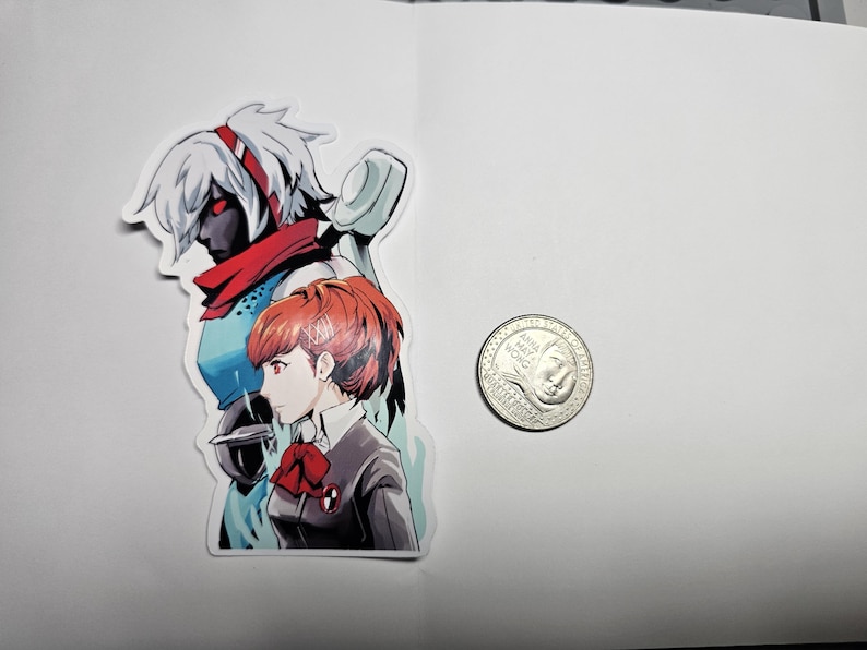 May include: A sticker featuring two anime characters. The character on the left is a woman with white hair, red eyes, and a red scarf. The character on the right is a woman with red hair, brown eyes, and a red bow. The sticker is on a white background.