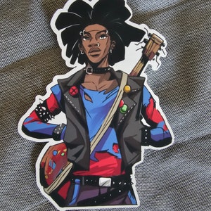 May include: A sticker of a cartoon person with black hair, wearing a blue and red shirt, a black leather jacket, and a guitar. The person has a variety of piercings and is wearing a black choker.