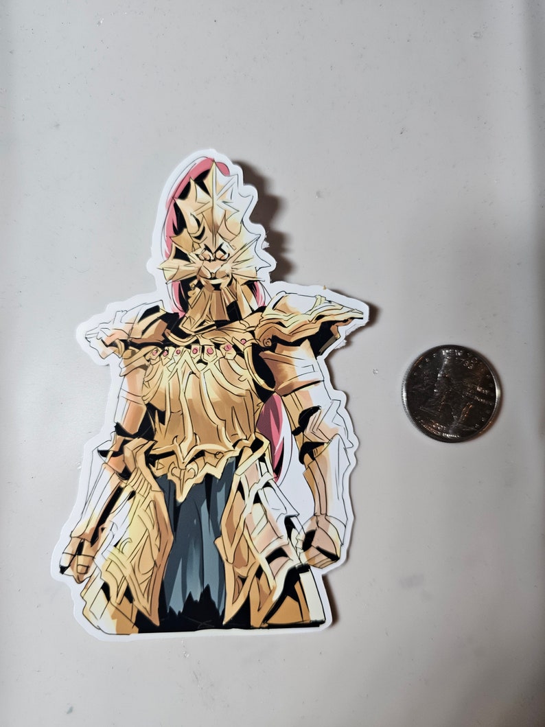 May include: A sticker of a golden knight wearing armor with a large, spiky helmet. The knight is standing with its arms at its sides. The sticker is on a white background.