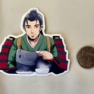 May include: A sticker featuring a cartoon man in a green and red samurai outfit, holding a bowl of food. He is seated at a table with two bowls of food in front of him.