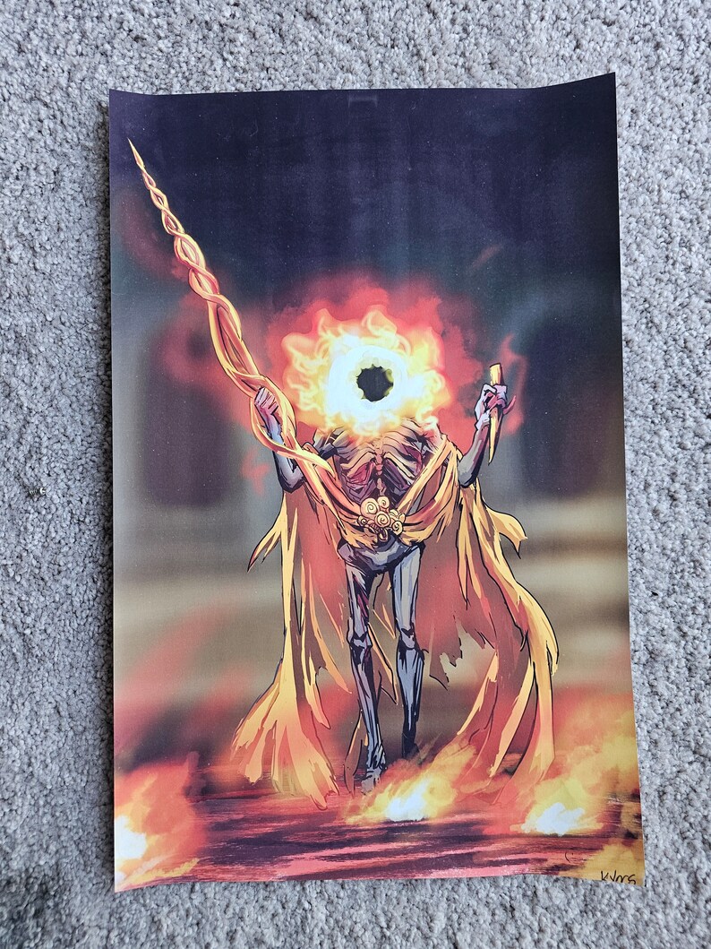 May include: An artistic print depicting a skeletal figure with a flaming head and a golden cape. The figure holds a staff and a knife, standing amidst flames. The artwork features a dark, ominous background with fiery hues.
